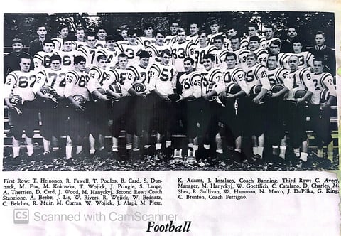 Black and white vintage football team photo with players in numbered jerseys and coaches standing in rows